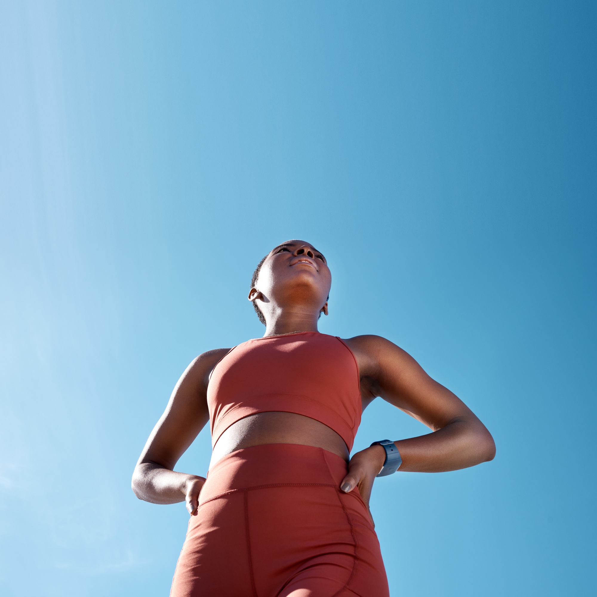 Low angle, sports fitness and black woman outdoor getting ready for workout, training or exercise w